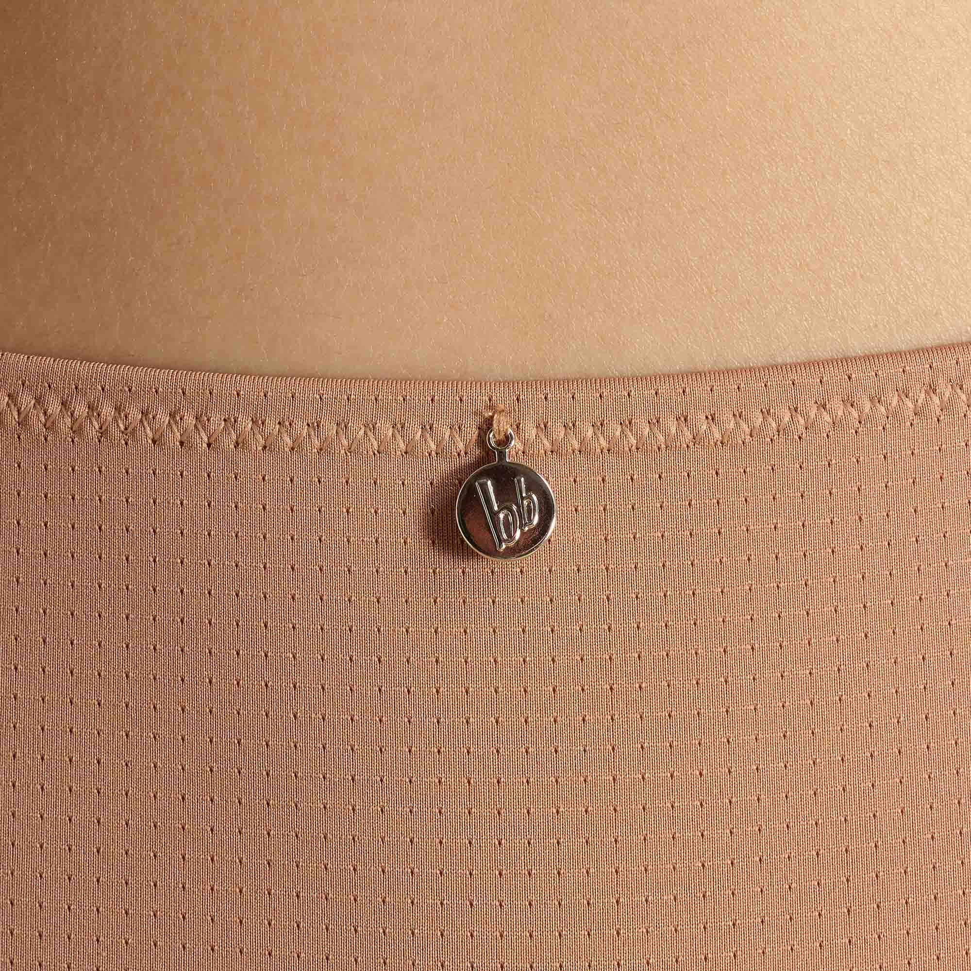 perforated fabric, peach top, round pendant, small charm, neckline